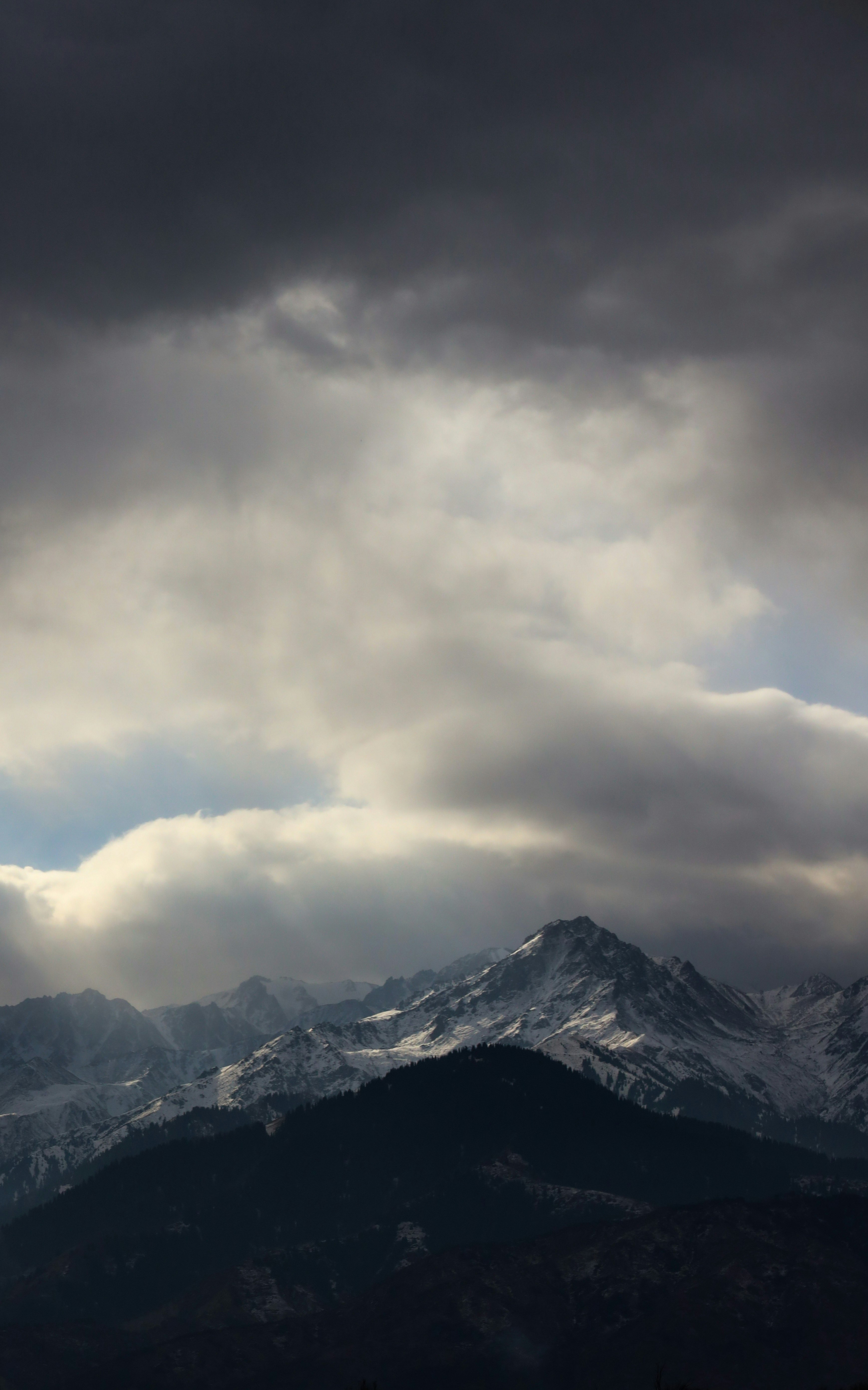 snow covered mountain under cloudy sky during daytime